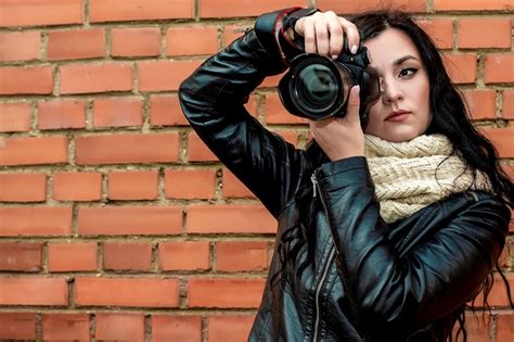 Premium Photo Portrait Of A Beautiful Brunette Girl Photographer With Long Curly Hair In Warm