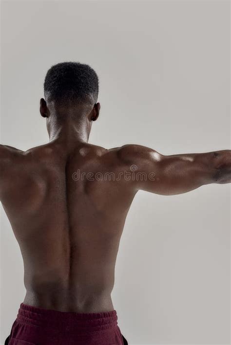 Swimmer Rear View Of Muscular Man With Naked Torso Raising His Arms Above Head Isolated Over