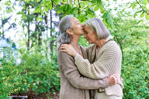 A Lesbian Couple In Cardigans Embrace Stock Photo Image Of Scenic Outdoors