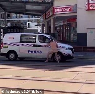 Bizarre Moment A Naked Man Wearing Runs In Front Of Police Wagon Before Diving Into The Back