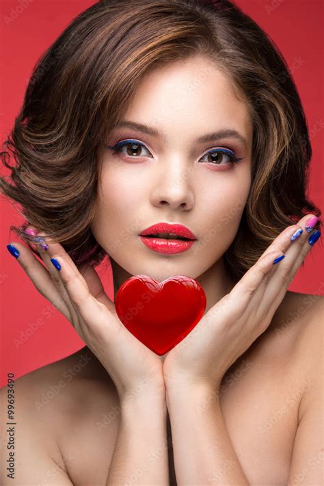 Beautiful Model Girl With Bright Pink Makeup And Red Heart In The Hands