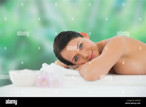Beautiful Brunette Relaxing On Massage Table Smiling At Camera Stock Photo Alamy