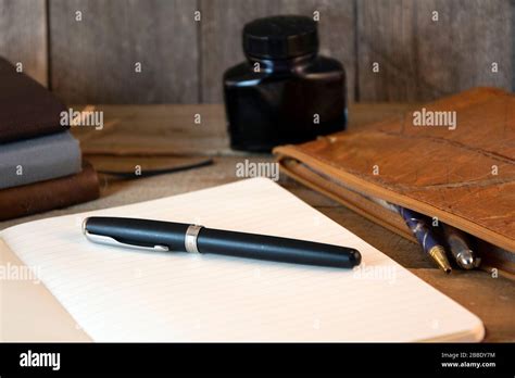 Open Notebook Pen Pencil Case And Ink With Wooden Background Stock