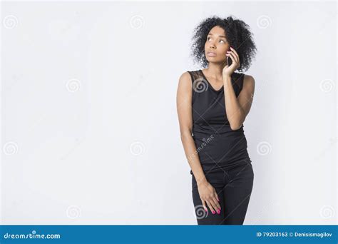 Serious African American Woman Is Talking On Her Phone Stock Image