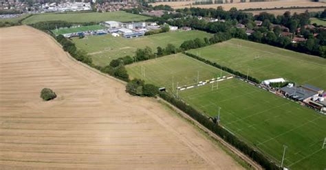 High Aerial View Over Canterbury Rugby Pitches Slow Pan Right