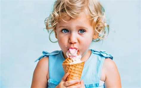 Premium Photo Blonde Toddler Model Eats Melting Ice Cream In Candy