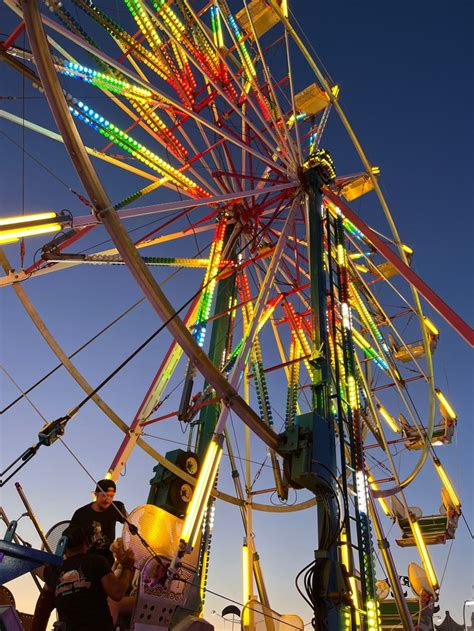 Brightly Lit Ferris Wheel At Night