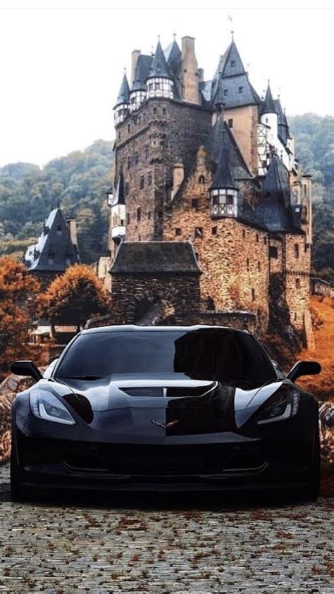 Classic Black Muscle Car Parked In Front Of A Castle