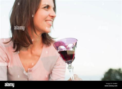 Mature Woman Drinking Glass Of Red Wine In Park Stock Photo Alamy