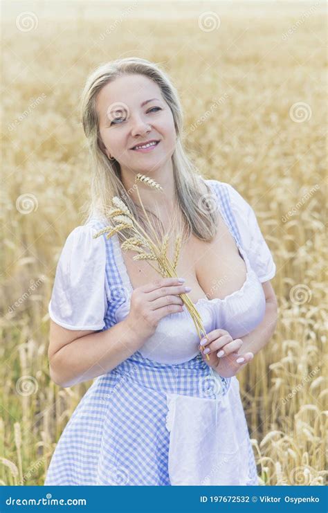 Blonde With Big Breasts Holds Spikelets In A Field With Wheat Stock Photo Image Of Agriculture