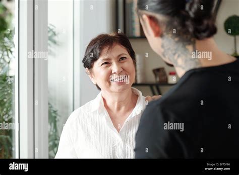 Happy Smiling Mature Mixed Race Woman Looking At Adult Son Visiting Her At Home Stock Photo Alamy