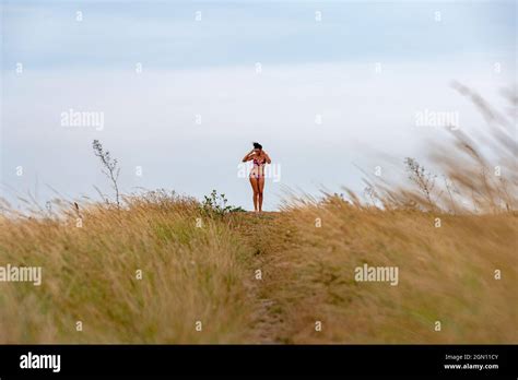 Woman On A British Beach Wearing A Bikini Stock Photo Alamy