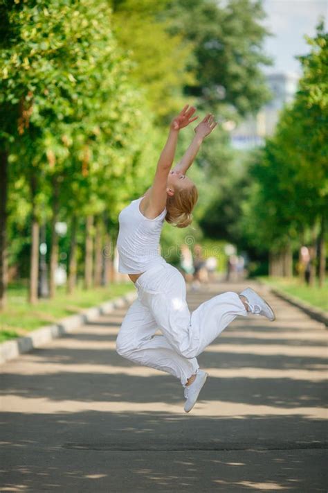 Blonde Girl Jumping In Summer Park Stock Photo Image Of Human Happiness