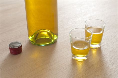 Two Full Shot Glasses With A Bottle Free Stock Image