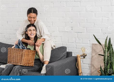 Cheerful Lesbian Woman Folding Clean Laundry Stock Photo Image Of