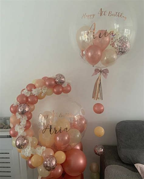 Some Balloons That Are In The Air Near A Chair And Table With Other