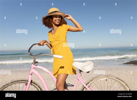 Mixed Race Woman With A Bike On The Beach Stock Photo Alamy