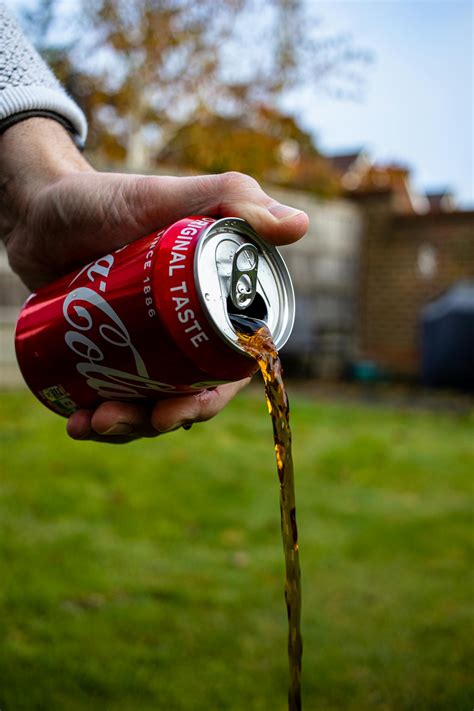 Person Pouring Coca Cola Can · Free Stock Photo