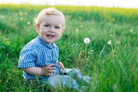 premium photo smiling baby sitting   grass