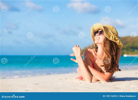 Long Haired Woman In Bikini And Straw Hat Lying On Tropical Beach Stock