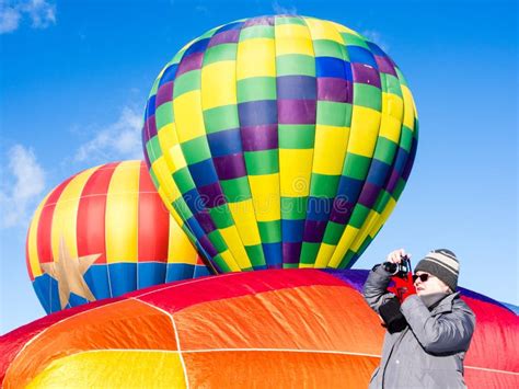Woman Taking Photos Of Hot Air Balloons Taking Off Editorial Image