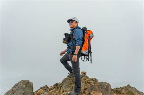 Hombre haciendo senderismo en las montañas con mochila Foto Premium