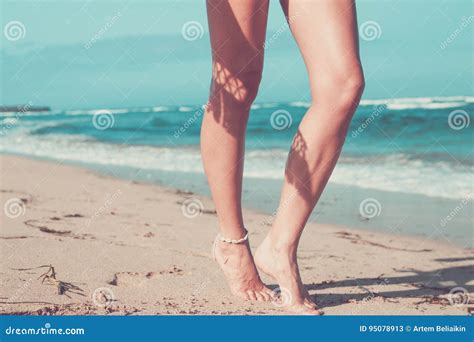 Tanned Legs Of A Woman Against The Sea Tropical Beach Scene Bali