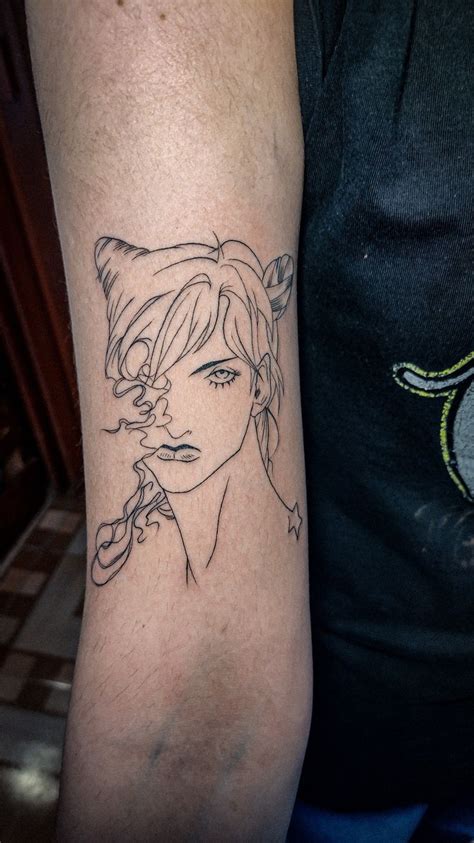 A Woman S Arm With A Tattoo On It That Has A Drawing Of A Girl