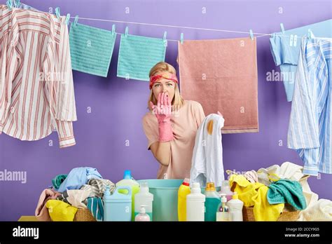 Beautiful Blonde Woman With Shocked Expression Closing Her Mouth With Palm Standing Behind The