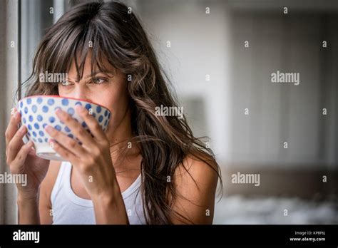 Woman Drinking Hot Beverage Stock Photo Alamy
