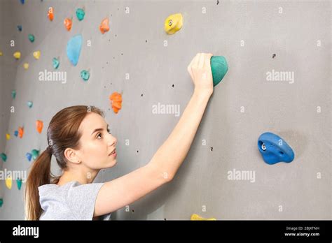 Young Woman Climbing Wall In Gym Stock Photo Alamy