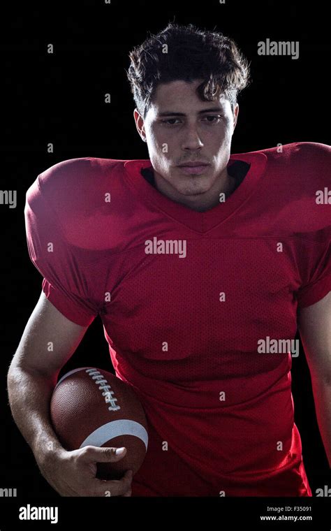 Serious American Football Player Holding Ball Stock Photo Alamy