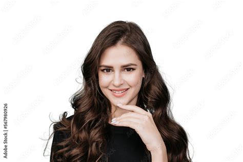Cute Brunette Hispanic Girl With Wavy Long Hair Looking At Camera Toothy Smiling Touching Her