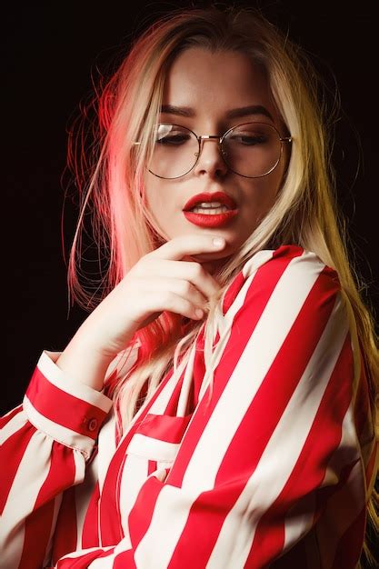 Premium Photo Luxurious Blonde Woman With Red Lips Wearing Glasses Posing With Colorful Light