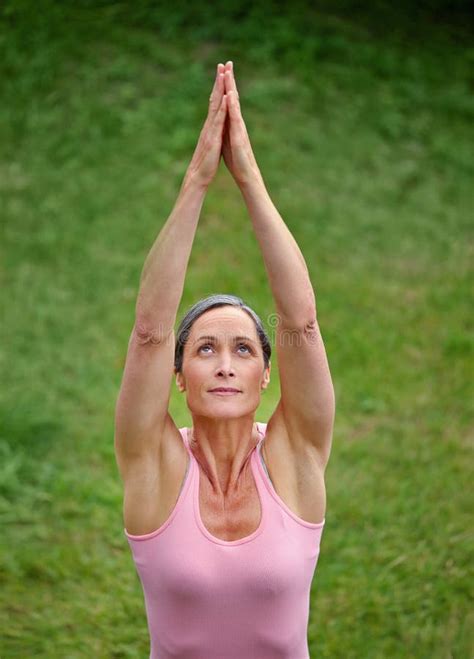 Yoga In The Fresh Air An Attractive Mature Woman Doing Yoga Outdoors Stock Photo Image Of