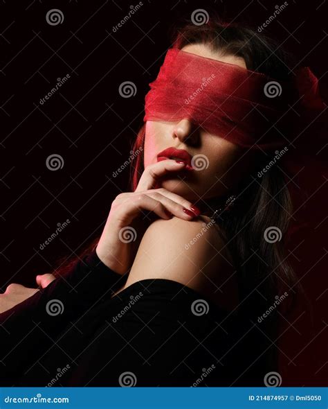 Portrait Of Excited Brunette Woman In Off Shoulder Dress And With Eyes Covered With Scarf