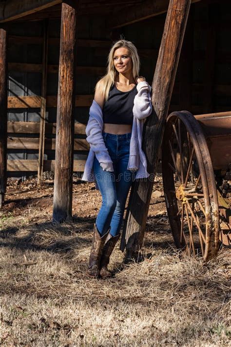 Lovely Blonde Model In Western Gear Poses Outdoor While Enjoying The Spring Weather Stock Image