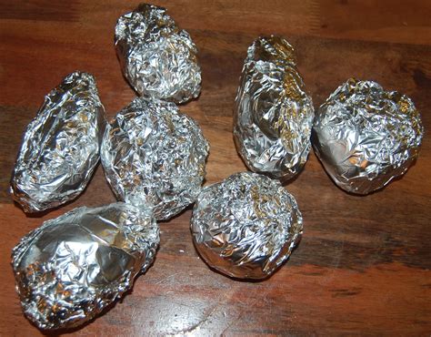 baked potato in oven wrapped in foil