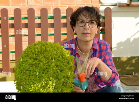 Brunette Woman Gardening In Her Beautiful Garden Stock Photo Alamy