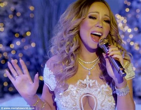 Mariah Carey belts Silent Night and sparkles in cleavage-baring white ...