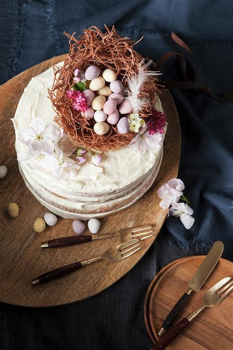 A Naked Sponge Cake Decorated With An Easter Nest Chocolate Eggs And