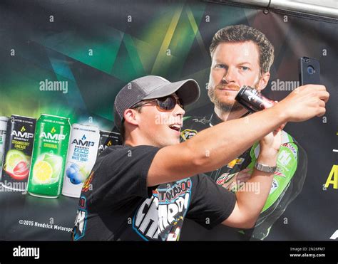 A Fan Takes A Selfie With A Dale Earnhardt Jr Poster And An Amp Energy