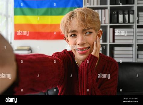 Good Mood Gay Man With Expansive Smile Holding Camera Taking Selfie On Mobile Phone At Home With