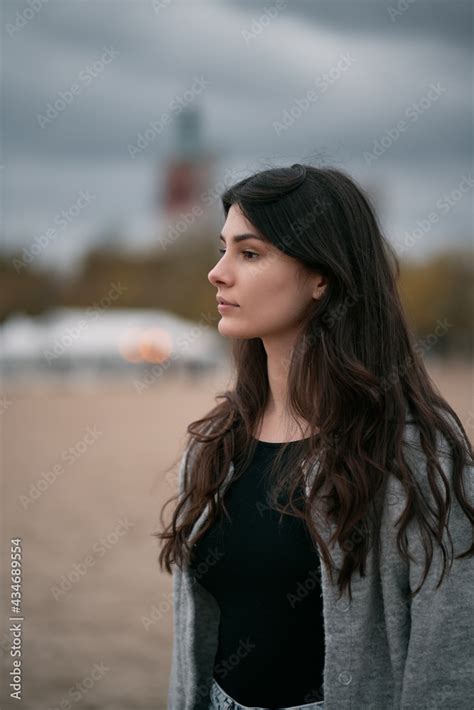 Sensual And Gorgeous Brunette On The Beach Clothed Woman On The Beach During Autumn Season On