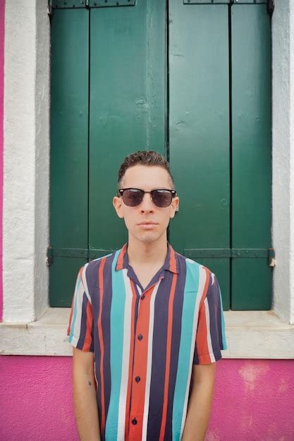 Premium Photo Portrait Of Man Wearing Sunglasses Standing Against Wall