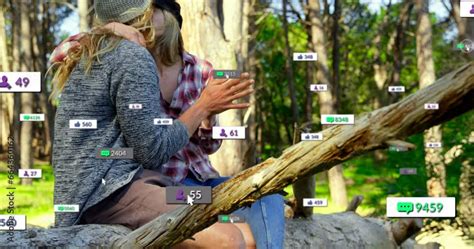 Animation Of Notification Bars Lesbian Over Caucasian Couple Kissing While Sitting On Tree Bark