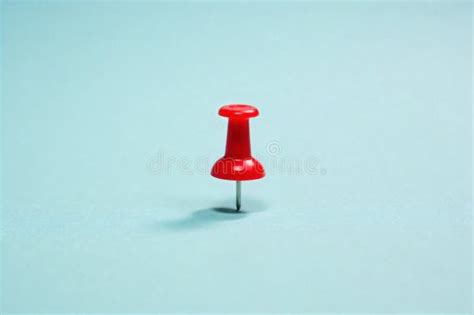 minimalist composition  single red push pin   stark white surface