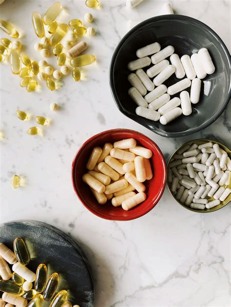 Set of dietary supplements for health support on marble tableFree Stock Photo