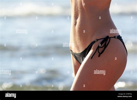 Closeup Of Slim Woman Belly In Black Bikini On Beach Stock Photo Alamy
