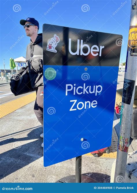 A Man Waits at Sign in the LAX-it (LA Exit) Lot for Ride App Services ...